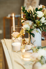 Elegant neutral coloured wedding table scape with flowers and candles