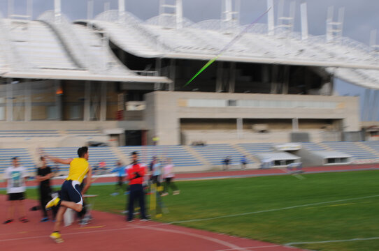 Athlete throwing javelin at track and field competition in stadium - Powered by Adobe