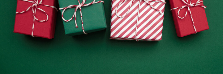 A row of Christmas presents in green and red paper on green