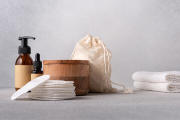 Natural skincare products featuring wooden containers, reusable cotton pads, eco-friendly packaging, and spa essentials