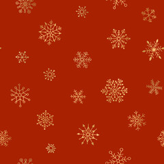 Seamless pattern of golden snowflakes. Red holiday background.