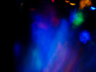 A colorful, blurry background with a rainbow of colors. The colors are bright and vibrant, creating a sense of energy and excitement. Abstract design wall paper. Cinematic light effect.