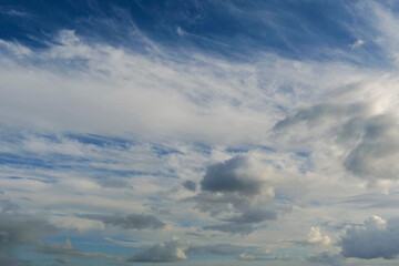 The sky is blue with a few clouds scattered throughout. The clouds are white and fluffy, giving the sky a peaceful and serene appearance