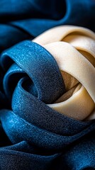  A tight shot of a blue fabric's knotted endpoint where two sections connect