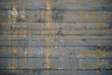 Concrete wall with wooden print on it left from decking. Background for design. Grey color surface.