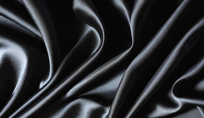 Obraz premium Soft black silk fabric texture with ripples and folds
