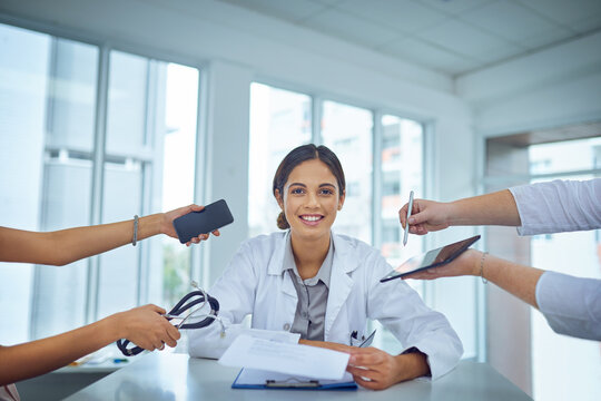 Doctor, portrait and woman with multitasking and hands to show workload and healthcare demand with smile. Confidence, medical and happy surgeon in clinic with clipboard and hospital care for job