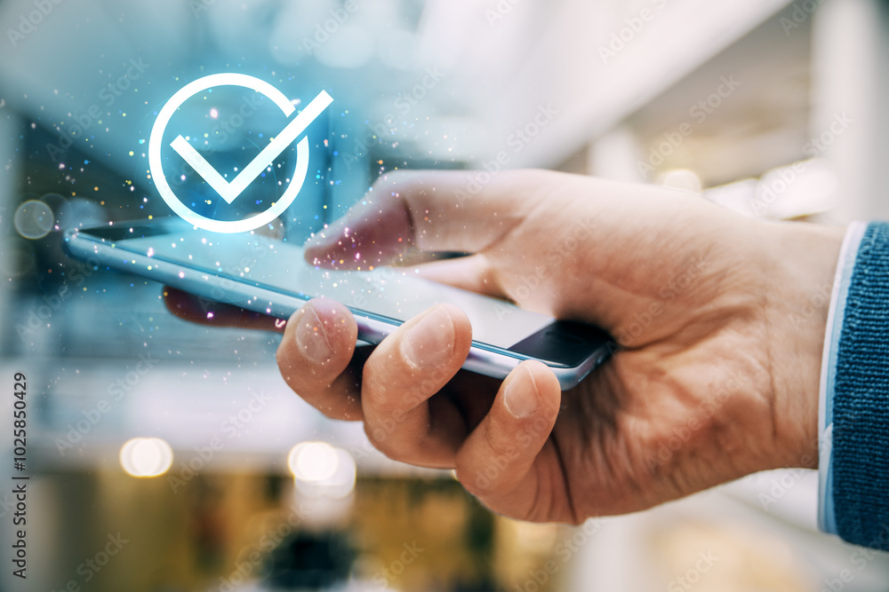 Poster hand holding smartphone with check symbol glowing above it.