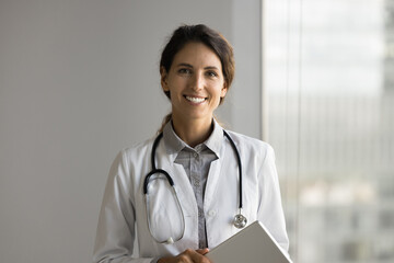 Headshot portrait young female doctor wear medical uniform confident physician trusted healthcare...