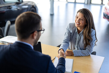 Car, dealership or documents with salesman and customer in showroom for conversation, deal or offer. Contract, finance or insurance with agent and woman in discussion for vehicle purchase