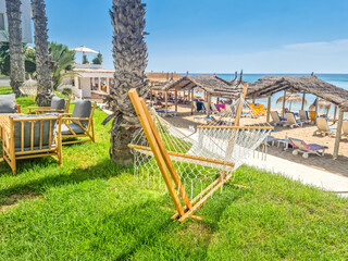 Hammock hanging on trees with a beach in the background