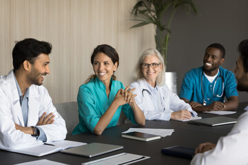 Happy laughing hospital staff team of different age gender speciality start workday from briefing...