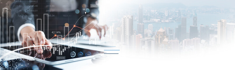 Business, finance and investment. Businessman using digital tablet analyzing financial data with...