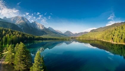 Reflections of trees dance on the calm surface.  