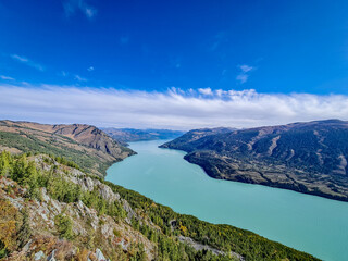 Fototapeta premium kanasi lake landscape or mountain view, scenery of mountain in China, travel destination or tour tourism, xinjiang, majestic panorama nature view. destination, blue sky, hill top, calmness.