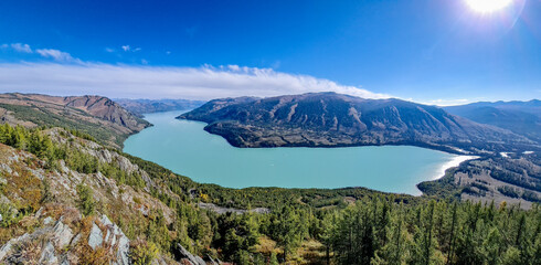 Obraz premium kanasi lake landscape or mountain view, scenery of mountain in China, travel destination or tour tourism, xinjiang, majestic panorama nature view. destination, blue sky, hill top, calmness.