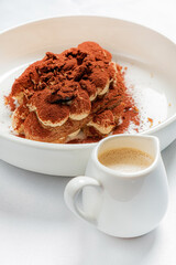 tiramisu cake with sauce on plate