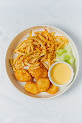 french fries with nuggets and sauce
