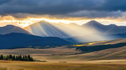 Obraz premium Sunlight Over Majestic Mountain Landscape at Dusk