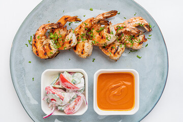 grilled shrimps with sauce and salad