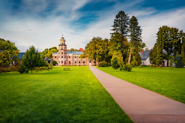 Empty road to old palace. Great morning view of Sigulda New Castle with green meadow and empty tourist path. Colorful summer cityscape Sigulda town, Siguldas novads, Latvia, Europe.
