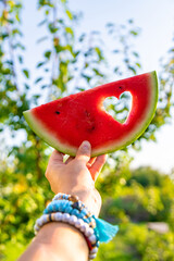 A heart-shaped piece of watermelon. Selective focus.