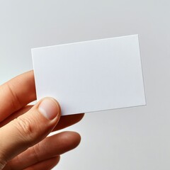 Obraz premium Hand Holding Blank White Business Card Mockup on White Background.