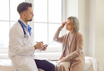 Doctor consulting female senior patient sharing symptoms, express dissatisfaction, annoyance about...