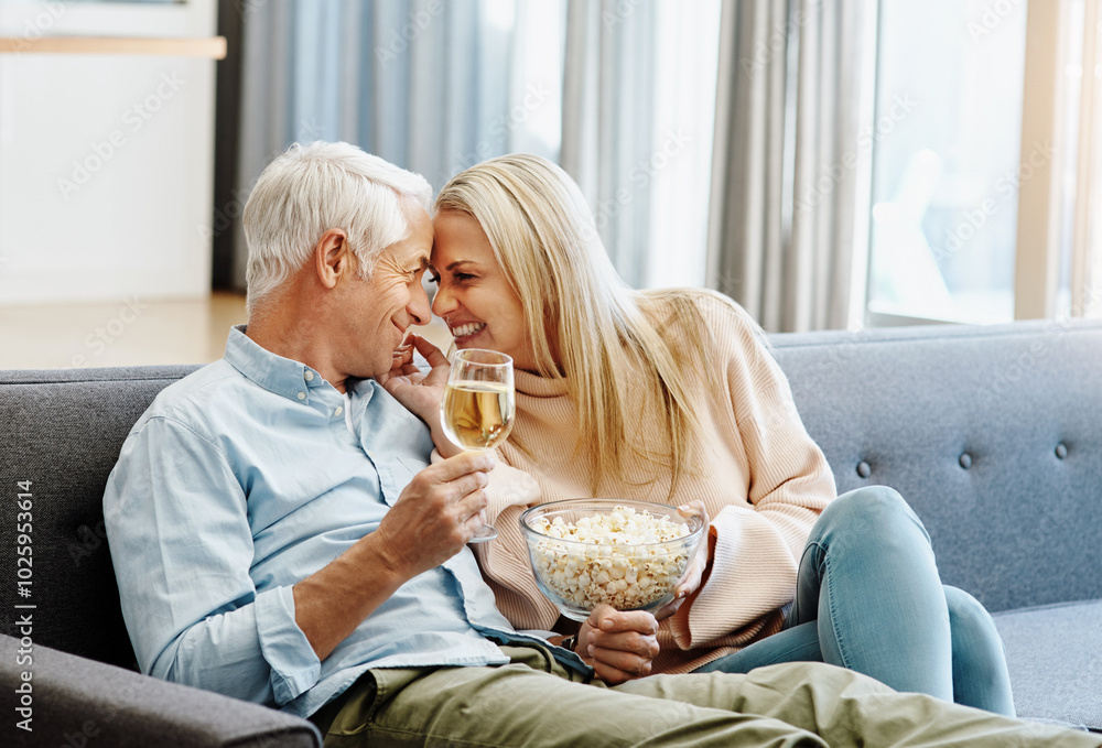 Sticker Mature, couple and relax with popcorn on sofa for romantic date, bonding and affection with champagne in home. People, love or drinking wine with snack on couch for cuddle, relationship or commitment