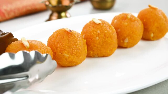 Serving laddu in a plate for diwali festival.