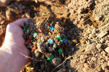 Microplastic pollution. Microplastics in ground. Soil contaminated with microplastics. Plastic...