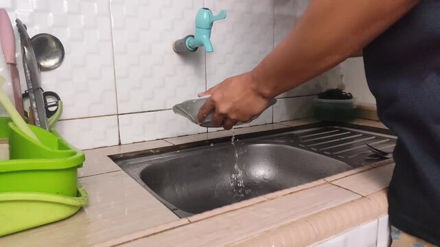 Man washing dishes in the sink