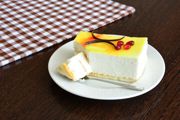 a slice of lemon cake on a plate next to a checkered towel