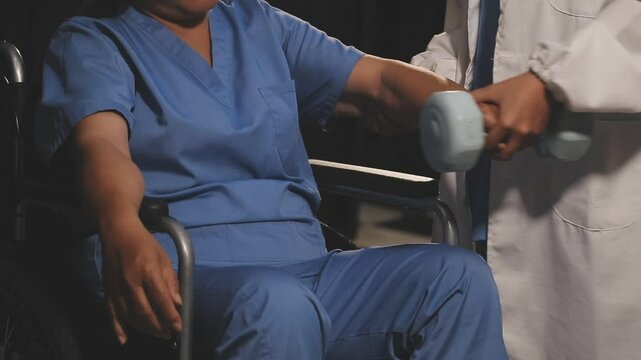 doctor is checking for muscle injuries and using dumbbells test injury and also help with physical therapy strengthen muscles because physical therapy will help strengthen muscles and help blood flow