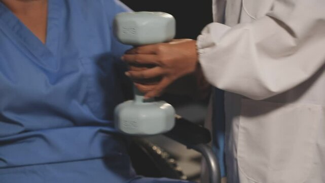 doctor is checking for muscle injuries and using dumbbells test injury and also help with physical therapy strengthen muscles because physical therapy will help strengthen muscles and help blood flow