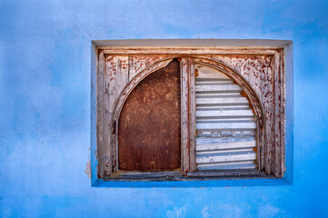 old window on blue wall