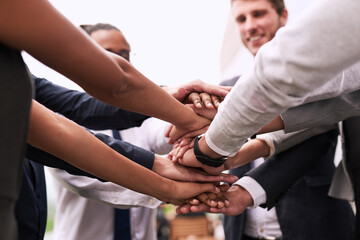 Business people, huddle or teamwork with hands together for motivation, mission or collaboration. Closeup, colleagues or employees piling in solidarity or meeting for unity, agreement or coordination