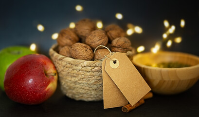 Autumn Set with Apples and Walnuts. Space for Text, Cozy Atmosphere with Defocused Lights on the Background. Autumn concept.