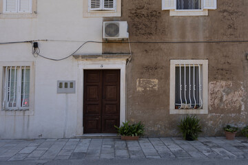 Old tenement house, damaged facade, old electrical installation