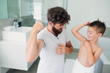 Muscle, bathroom and child with dad for washing, cleaning and hygiene in home together. Family, happy and father with young boy flex for learning skincare, wellness and health for morning routine
