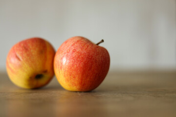 Ripe apples on a wooden table, shallow depth of field.