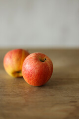 Ripe apples on a wooden table, shallow depth of field.	