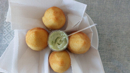 coxinha stick with mayonnaise sauce in paper box