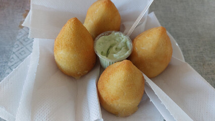 coxinha stick with mayonnaise sauce in paper box