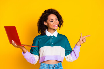 Portrait of good mood girl with wavy hair wear striped shirt hold laptop directing look empty space...
