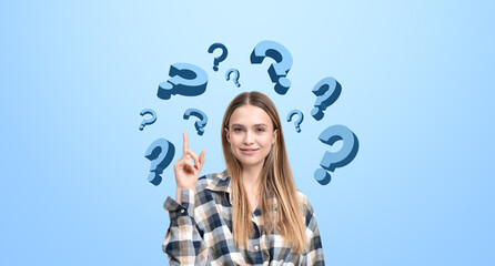 Young woman with question marks on blue background, concept of c