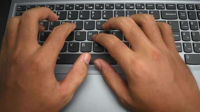 close up top view of timelapse fast hands typing gesture on laptop keypad