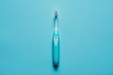 Electric toothbrush on a blue background for personal hygiene routine