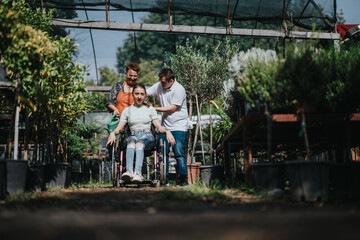 A boy with Down syndrome, a girl in a wheelchair, and an elderly woman enjoy time together in a...