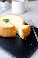 A delicious slice of cheesecake with a cup of tea. Perfect for food blogs, recipes, and restaurant marketing.